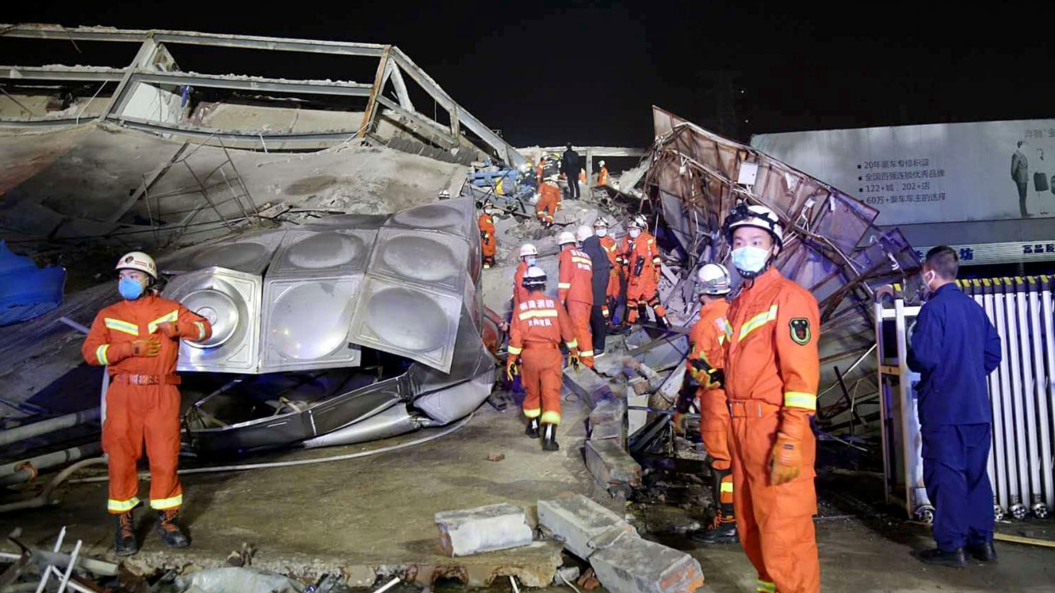 Rescuers work at the site of a collapsed five-story hotel building in Quanzhou city in southeast China's Fujian province Saturday, March 7, 2020.