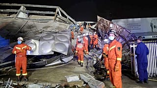 Rescuers work at the site of a collapsed five-story hotel building in Quanzhou city in southeast China's Fujian province Saturday, March 7, 2020.