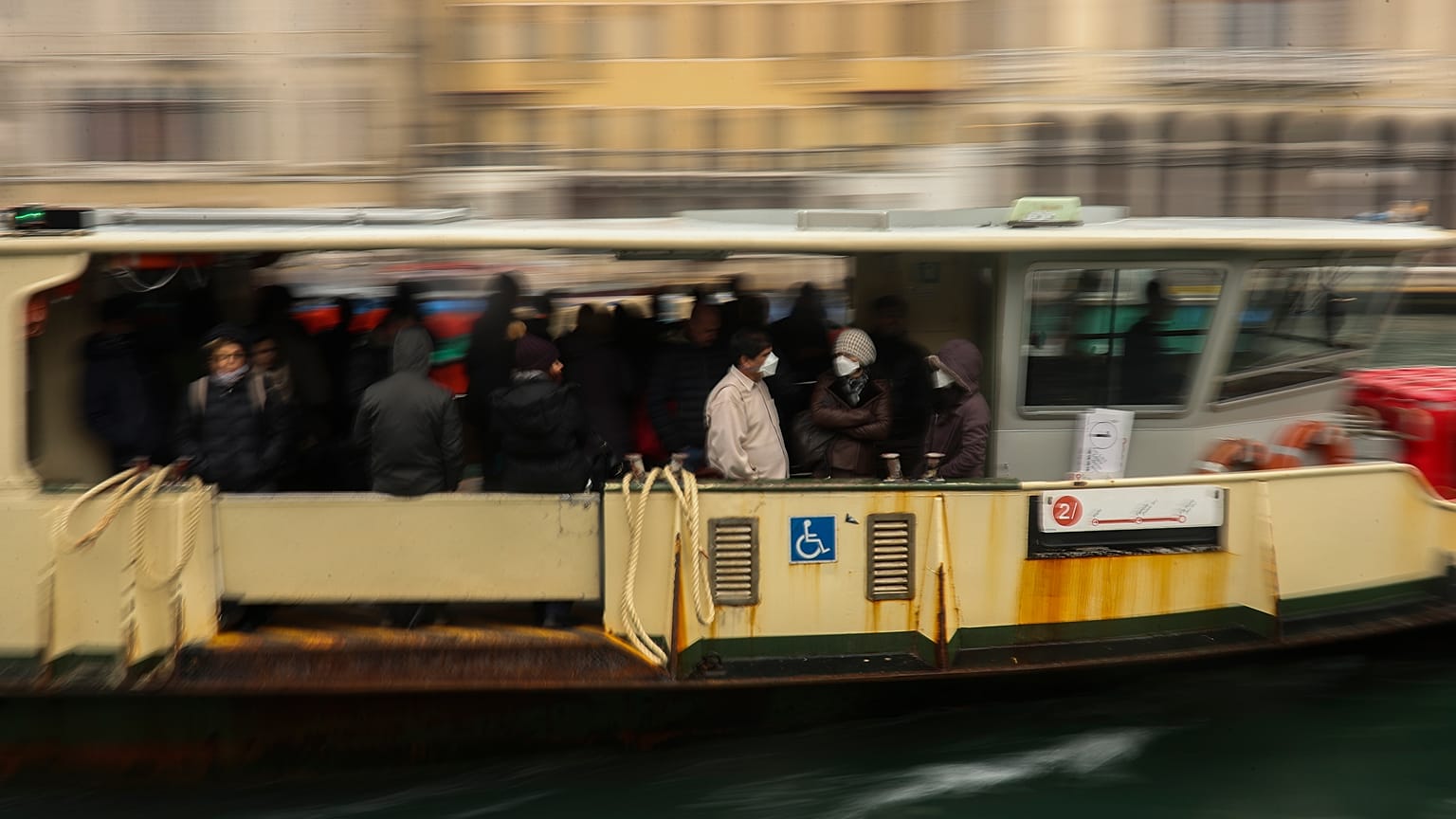 In this March 2, 2020 photo, commuters and locals take a bus boat in Venice, Italy.