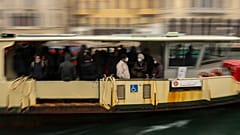 In this March 2, 2020 photo, commuters and locals take a bus boat in Venice, Italy.