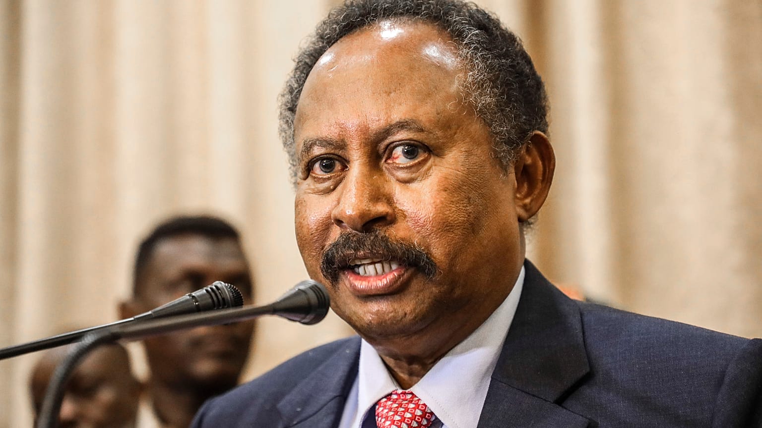 In this Aug. 21, 2019, file photo, Sudan's new Prime Minister Abdalla Hamdok speaks during a press conference in Khartoum, Sudan. 