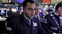 Specialist Dilip Patel, left, works at his post on the floor of the New York Stock Exchange, Monday, March 9, 2020