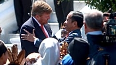 King Willem-Alexander of the Netherlands is welcomed by Indonesian President Joko Widodo on his arrival at the presidential palace in Bogor. 