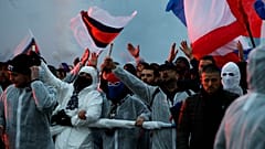 PSG supporters chant as they gather prior a Champions League round of 16 second leg soccer match between Paris-Saint-Germain and Borussia Dortmund at the Parc des Princes stad