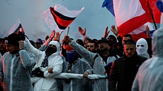 PSG supporters chant as they gather prior a Champions League round of 16 second leg soccer match between Paris-Saint-Germain and Borussia Dortmund at the Parc des Princes stad