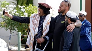 Al Noor mosque attack survivor, Taj Mohammad Kamran, left, takes a selfie with friends outside the Al Noor mosque in Christchurch, New Zealand