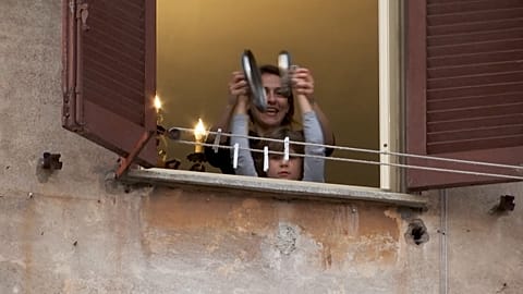 Italians sing, clap, vow to remain united on virus