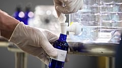 A worker bottles hand sanitizer made at the Eight Oaks Farm Distillery in the USA