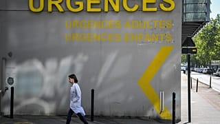 A doctor walks past the entrance of the emergency service of the University Hospital (CHU) in Nantes, western France on April 30, 2019