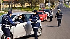 Members of the Rome Local Police check the documents and the self-declarations of motorists on the Via Pontina, in Rome, on March 21, 2020