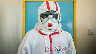 A doctor gets ready with protective gears before visiting the ward for quarantined people who had close contacts with the Kenyan patient of the COVID-19