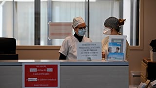 Nurses wearing protective face masks are pictured 