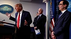Donald Trump speaks about the coronavirus in the James Brady Briefing Room, Wednesday, March 25, 2020, in Washington as Mike Pence and Treasury Secretary Steven Mnuchin listen