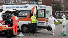 Une équipe médicale se prépare à recevoir un malade transféré par hélicoptère à l'hôpital de Brescia, en Lombardie, le 27 mars 2020
