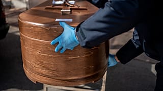 The coffin containing remains of a victim of the COVID-19 is taken for cremation at the Almudena cemetery in Madrid, Spain, Saturday March 28, 2020.