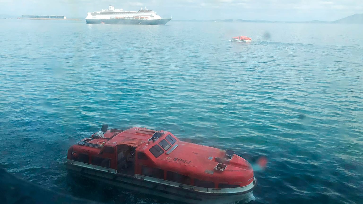 In this Saturday, March 28, 2020 photo made available by Juan Huergo, a tender approaches the Zaandam, a Holland America cruise ship off Panama. 