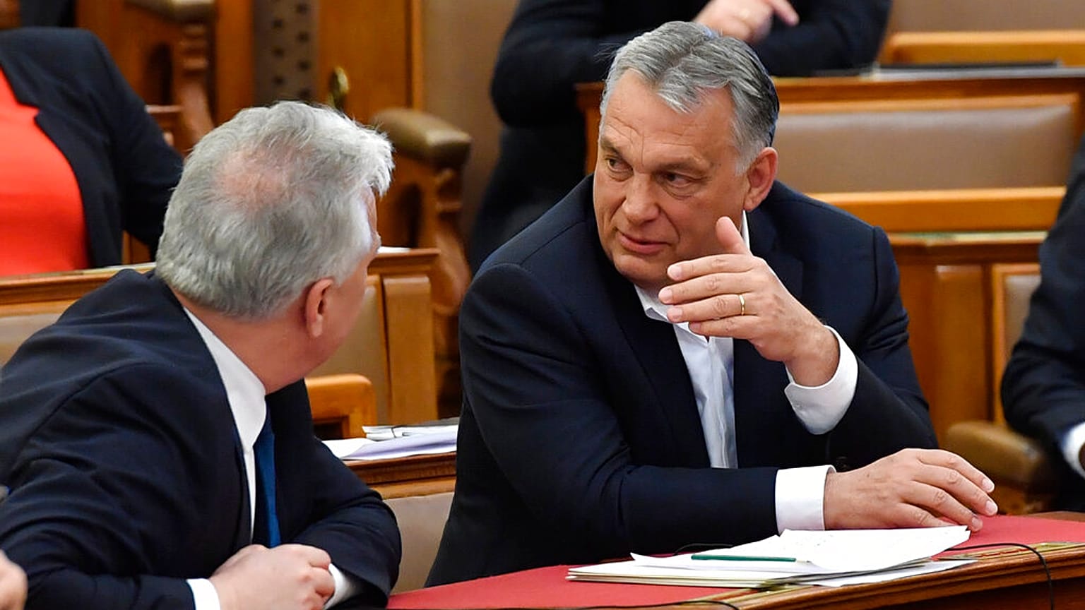 Hungarian Prime Minister Viktor Orban, right, chats with his deputy Zsolt Semjen during a plenary session of the Parliament in Budapest, Hungary
