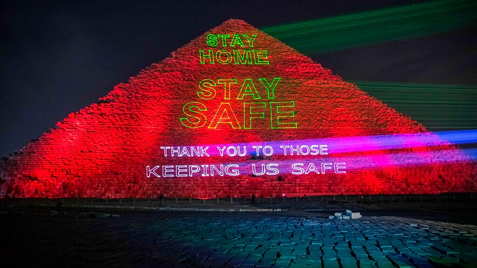 Messages of support for health workers are displayed on a pyramid in Egypt