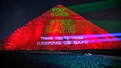 Messages of support for health workers are displayed on a pyramid in Egypt