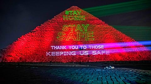 Messages of support for health workers are displayed on a pyramid in Egypt