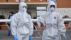 Female wearing a protective mask and overalls stand at the entrance of the Nomentana hospital in Fonte Nuova - Tor Lupara, near Rome, Italy