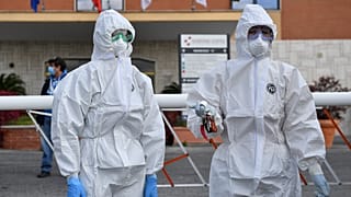 Female wearing a protective mask and overalls stand at the entrance of the Nomentana hospital in Fonte Nuova - Tor Lupara, near Rome, Italy