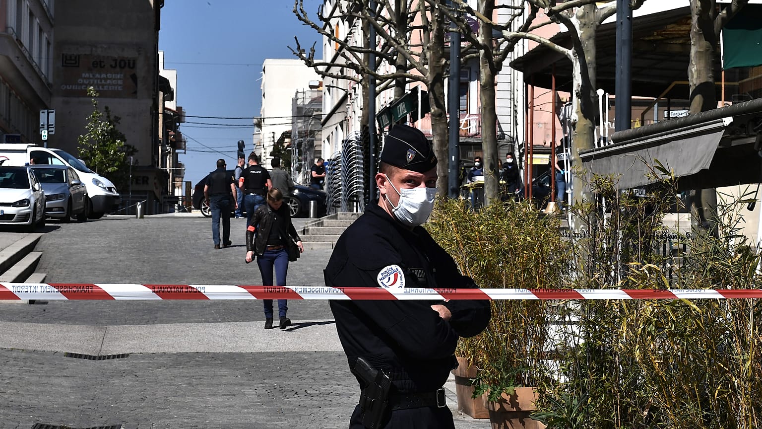 French Police officers stand in a street in the centre of Romans-sur-Isere, on April 4, 2020.