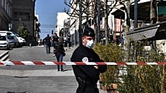 French Police officers stand in a street in the centre of Romans-sur-Isere, on April 4, 2020.