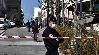 French Police officers stand in a street in the centre of Romans-sur-Isere, on April 4, 2020.