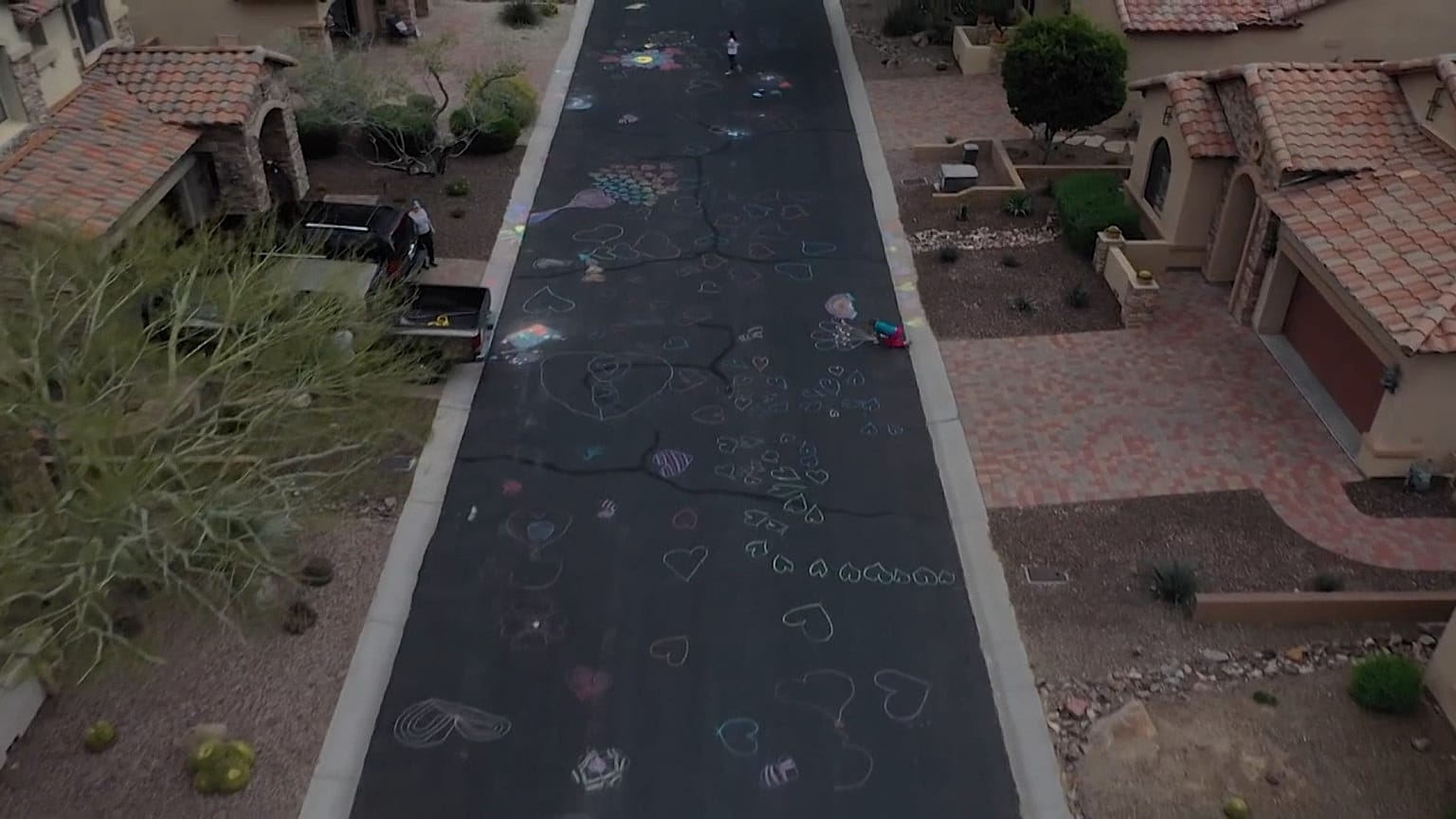 Spreading the love: Sisters cover road with hearts to lift spirits amid coronavirus pandemic