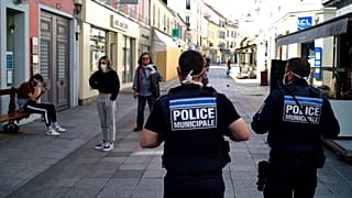 Municipal police officers patrol in a street of Sceaux during nationwide confinement measures to counter the Covid-19, in Sceaux, south of Paris, Wednesday, April 8, 2020.