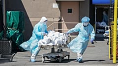Bodies are moved to a refrigeration truck serving as a temporary morgue at Wyckoff Hospital in the Borough of Brooklyn on April 6, 2020 in New York.