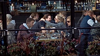 Ein Päarchen umarmt sich auf der Terrasse eines Restaurants in Stockholm, 4. April 2020