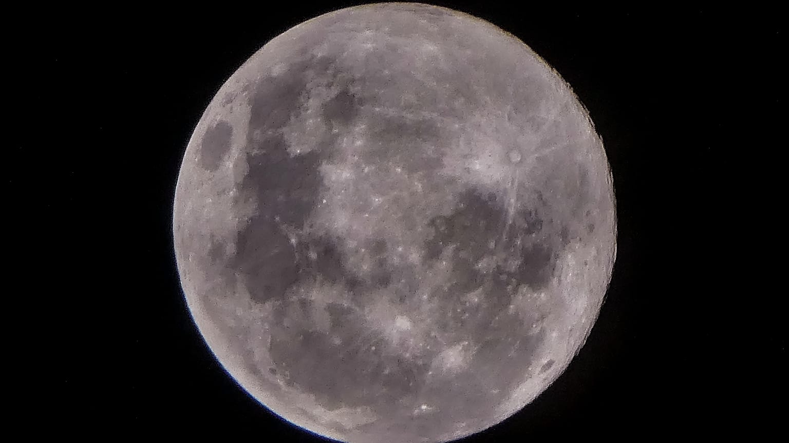 Thin clouds cover the 'Supermoon', also know as a pink moon. The view from Jakarta, Indonesia