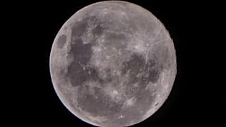 Thin clouds cover the 'Supermoon', also know as a pink moon. The view from Jakarta, Indonesia