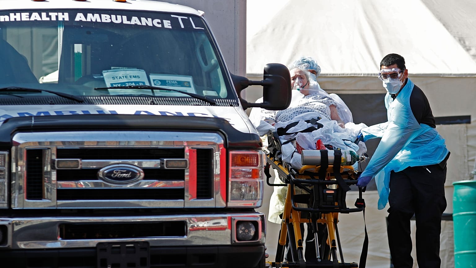 A patient is wheeled to an ambulance in New York