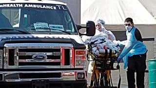 A patient is wheeled to an ambulance in New York