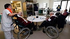 A care worker looks after residents of the Maharin nursing home of Anglet, southwestern France, Tuesday, Jan.30, 2018.