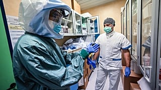 A nurse puts on his Personal Protective Equipment (PPE) at the Policlinico di Tor Vergata hospital, in Rome on April 8, 2020.