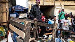 A shopkeeper watches as a bulldozer demolishes informal shops in an effort to stop the spread of the coronavirus, Dakar, Senegal, March 22, 2020.