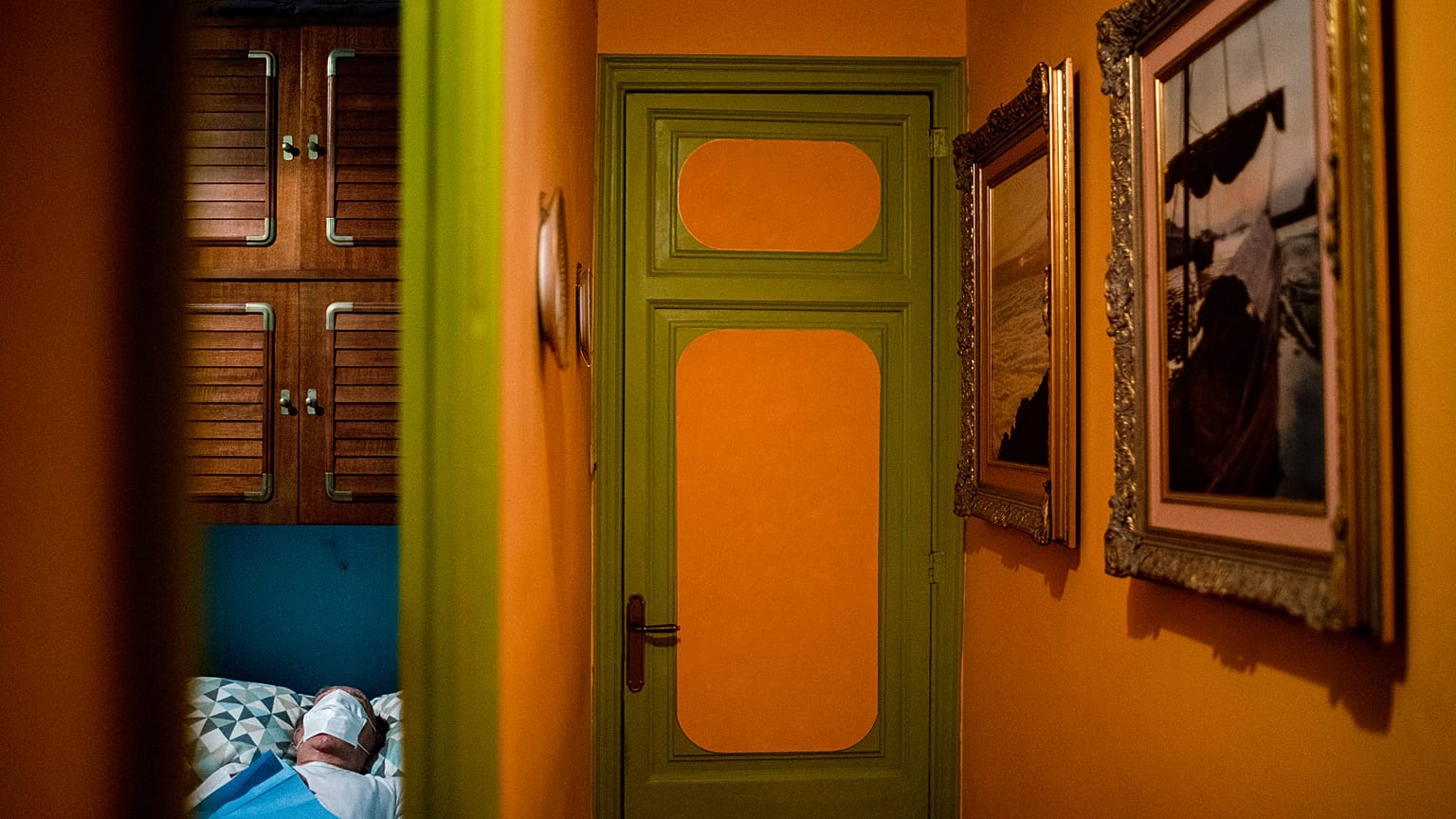 Enrique Pastor, 86, lies in bed as he waits for the doctor to examine him during a home medical visit. Pastor's usual caregiver tested positive for COVID-19. Barcelona, Spain