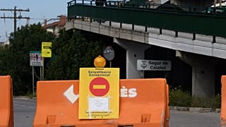 A temporary barriert blocks a road in Calafell to control people's movement
