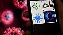 This illustration shows Coronavirus tracking applications logos, Healthlynked Covid-19, Covid Symptom Tracker, Apple Covid-19, Covid-19 tracker