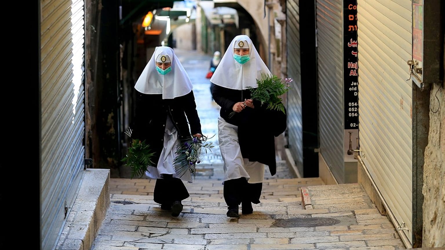 Nuns walk along the Via Dolorosa 