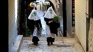 Nuns walk along the Via Dolorosa 