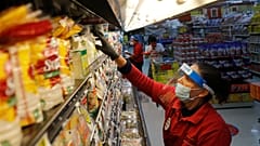 Amid concerns of the spread of COVID-19, Maclola Orozco restocks food at El Rancho grocery store in Dallas, Monday, April 13, 2020.