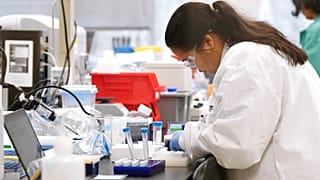 A researcher at Protein Sciences works in a lab, Thursday, March 12, 2020, in Meriden, Conn. The biotech company is currently researching a vaccine for COVID-19.