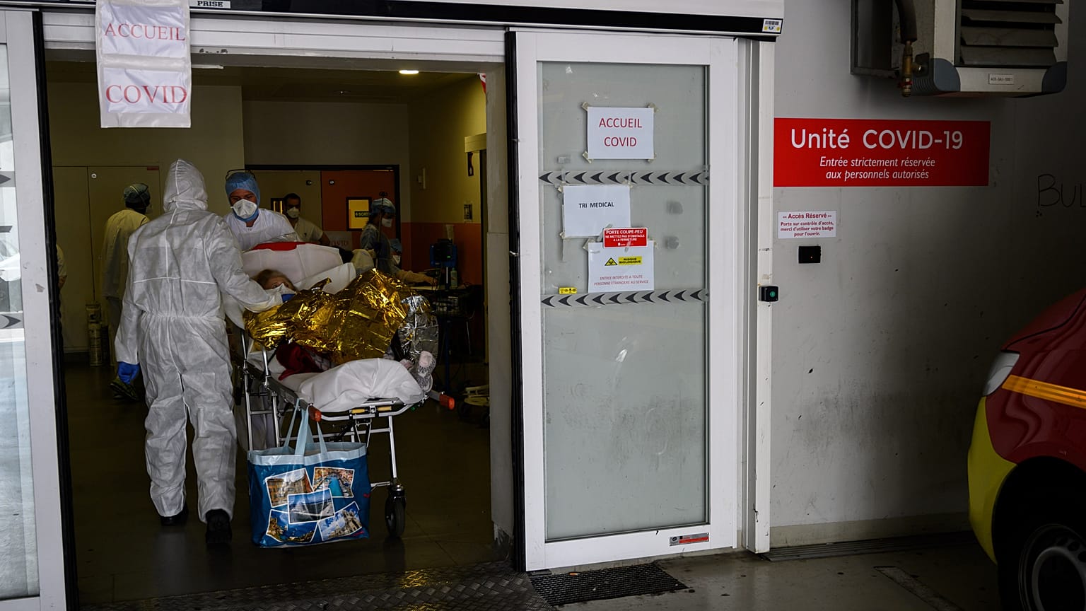 A firefighter from the Marins-Pompiers of Marseille carries an old woman suspected of being infected with COVID-19 at the Timone Hospital in Marseille, on April 15, 2020