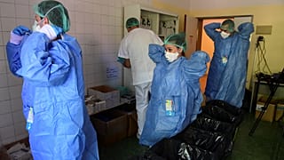 Members of the medical staff at the COVID-19 unit of the Policlinico Sant'Orsola-Malpighi hospital in Bologna on April 15, 2020