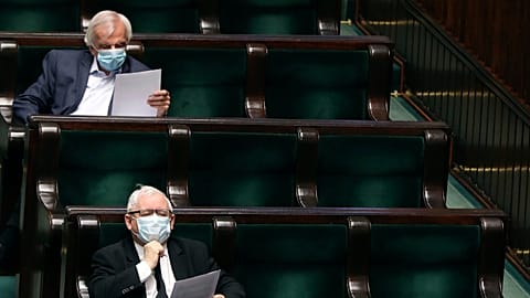 Leader of Poland's conservative ruling party, Jaroslaw Kaczynski, bottom, and prominent party member Ryszard Terlecki, top, in parliament, in Warsaw, Poland, on April 16, 2020